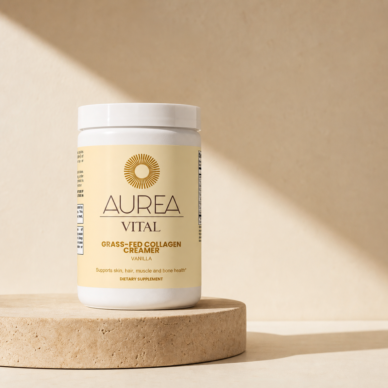 Aurea Vital Grass-Fed Collagen Creamer in a warm travertine studio setting.